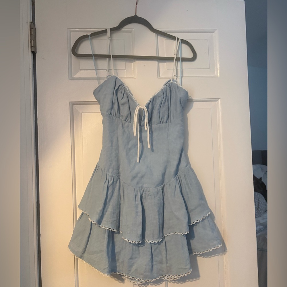Blue mini dress with white lace trim and tie back detail
